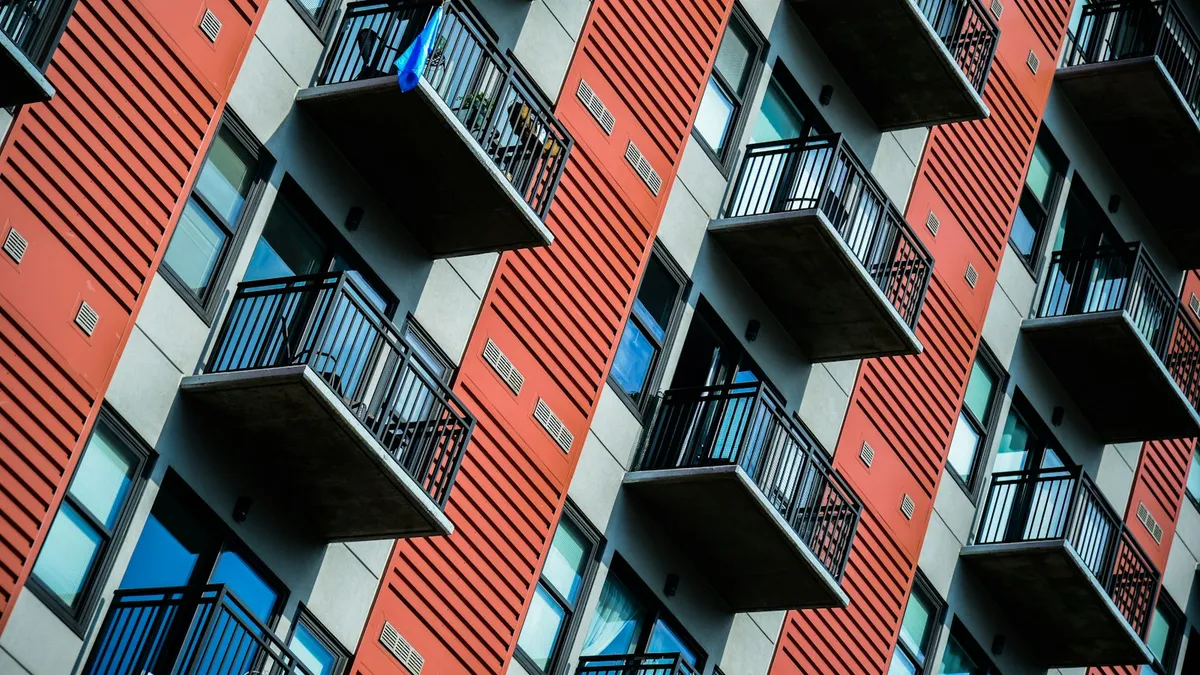 Tall red apartment building with balconies