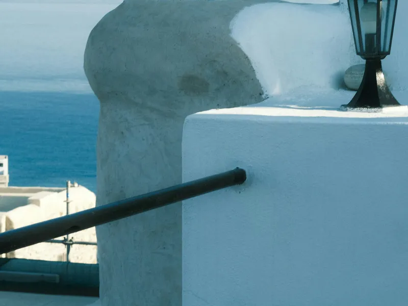 [[ Reference photo — replace with a real photo of the flat ]] Detail of a white facade with a lamp and sea view